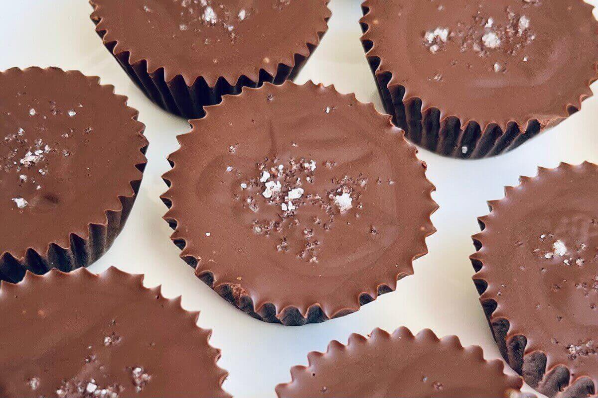 Chocolate sunflower cups on a white plate.