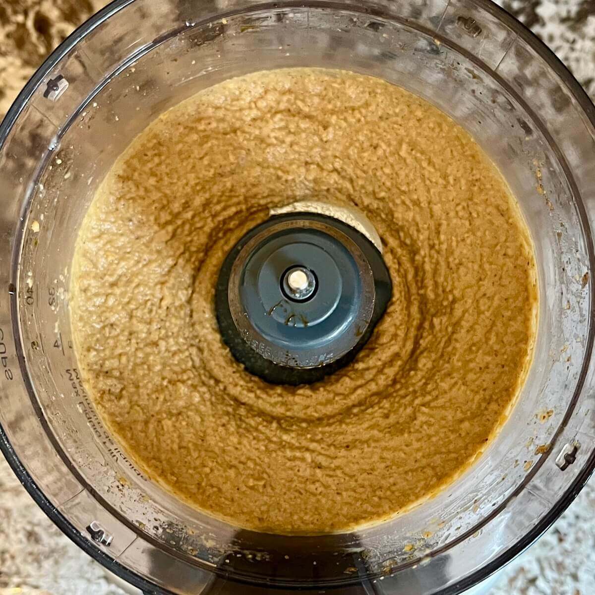 Blended hummus in a food processor.