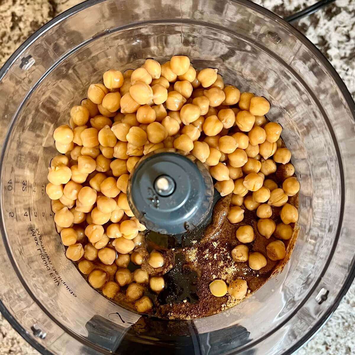 Ingredients for hummus in a food processor.