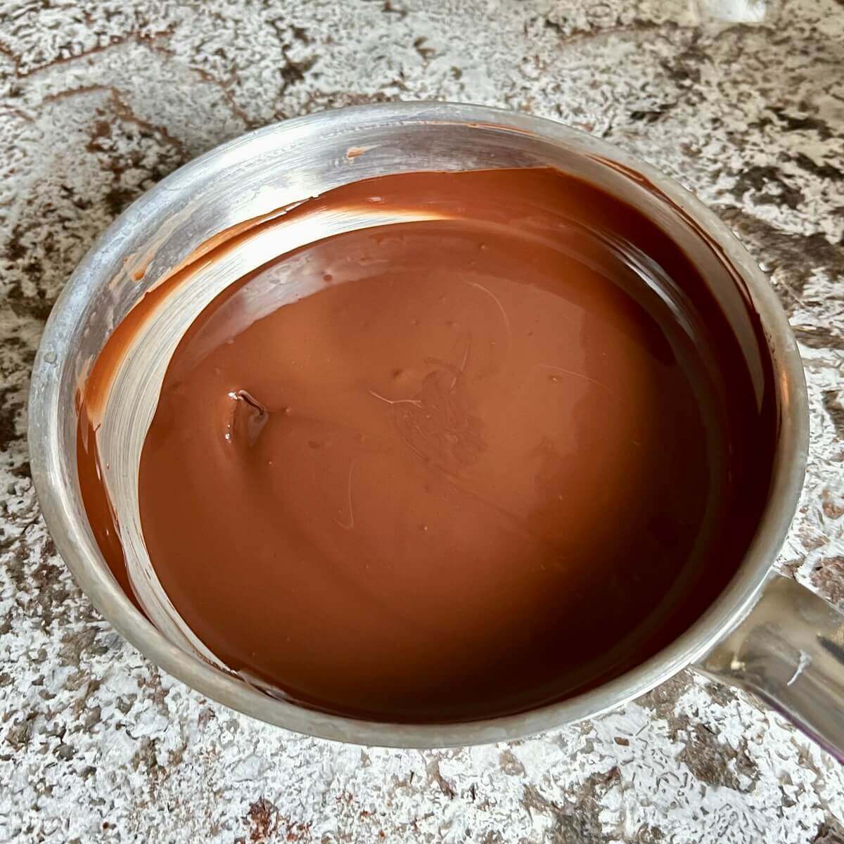 Melted chocolate in a steel pan.