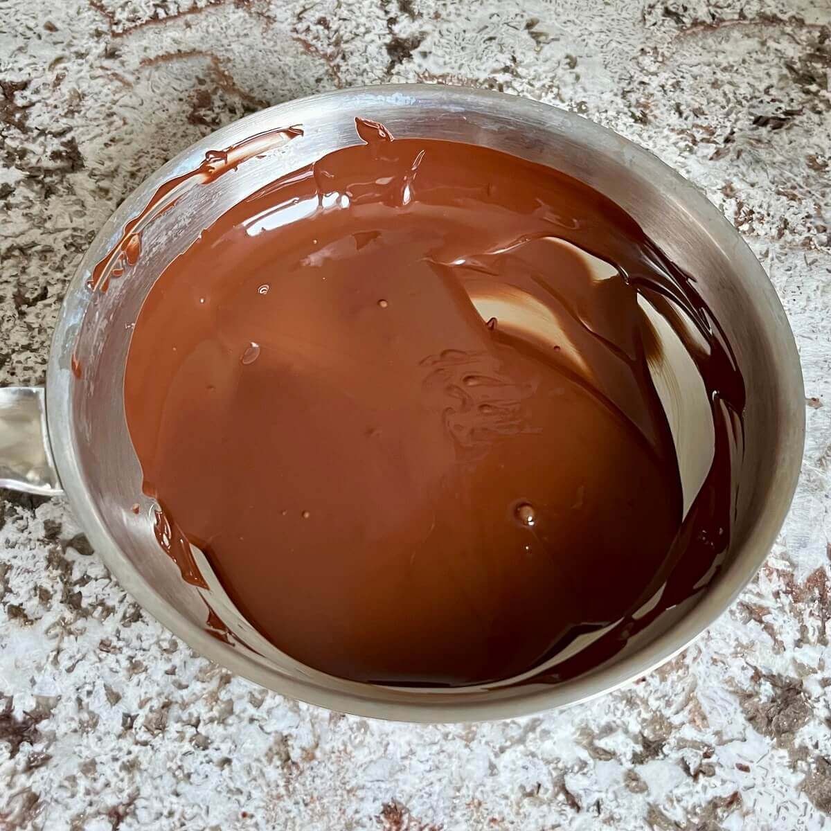 Melted dark chocolate in a pan.