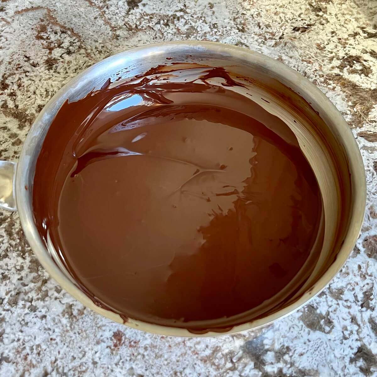 Melted chocolate in a steel pan.