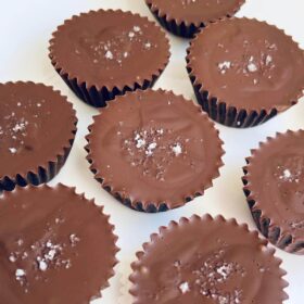 Sunflower seed butter cups sprinkled with sea salt on a white plate.