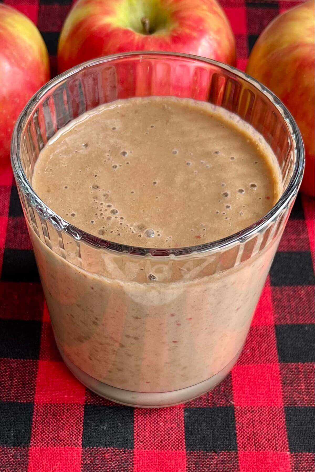 An apple smoothie in a glass.