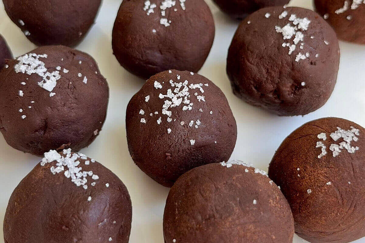 Avocado chocolate truffles on a plate.