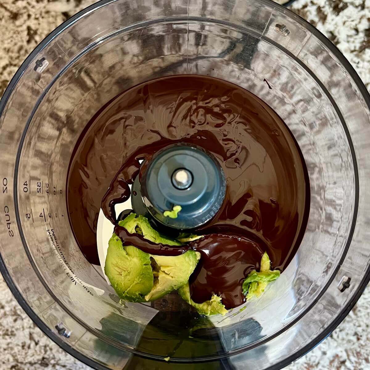 Avocado and melted dark chocolate in a food processor.