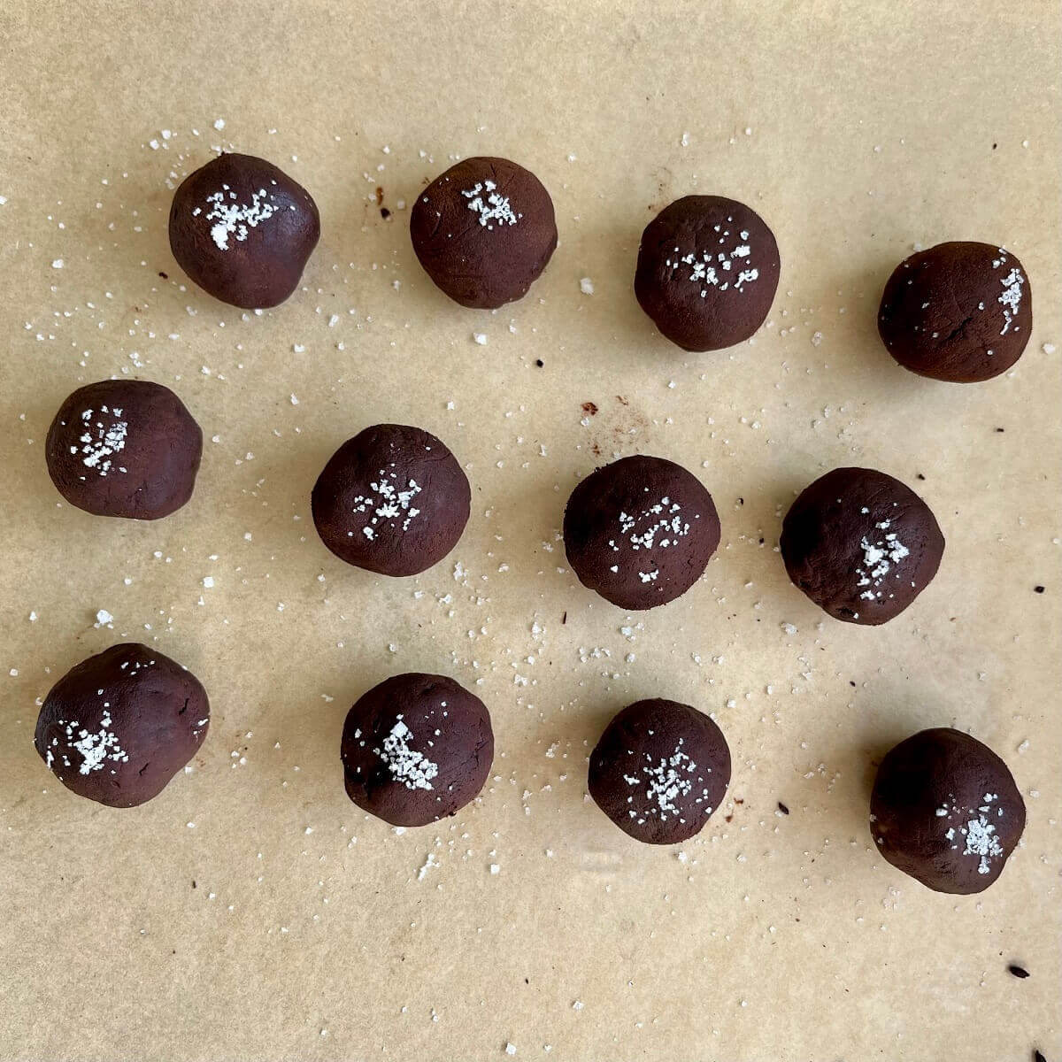 Avocado chocolate treats on a sheet pan lined with parchment paper.