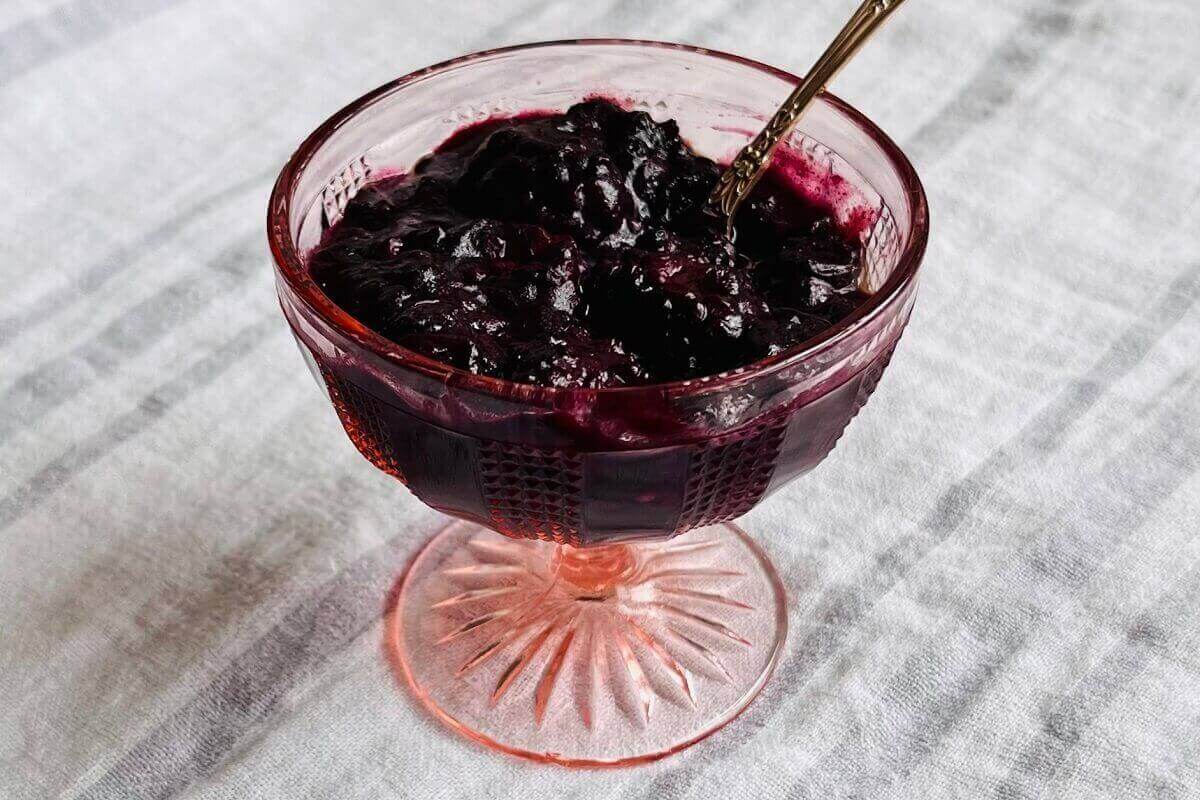 Baked blackberries and blueberries in a glass dish.