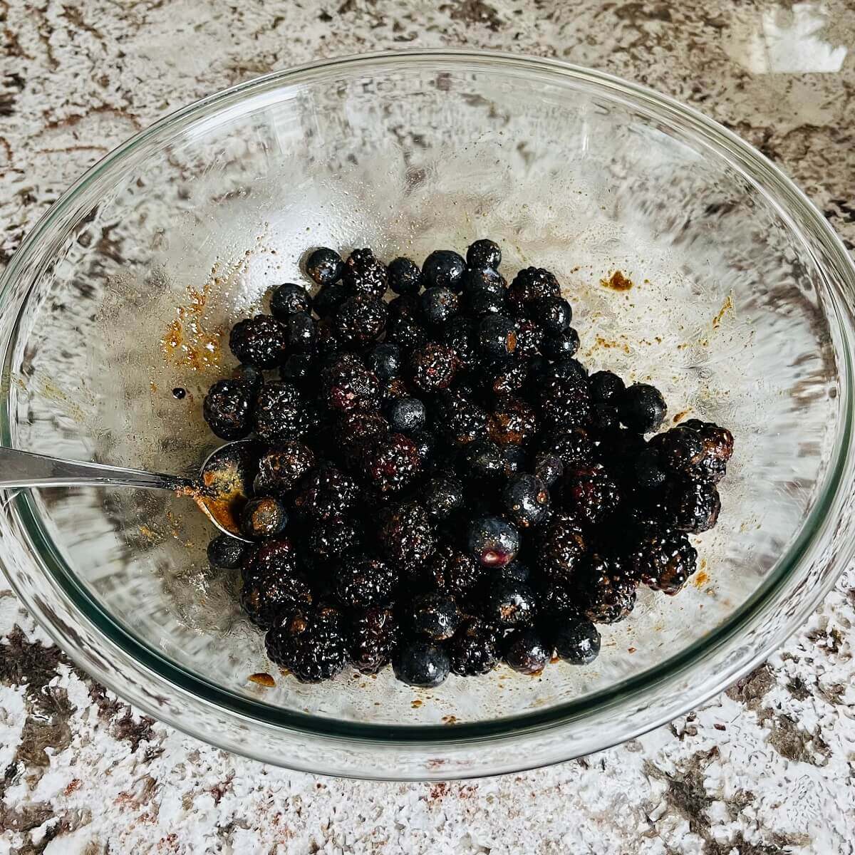 Berries, coconut sugar, whole wheat flour, and lemon juice in a mixing bowl.