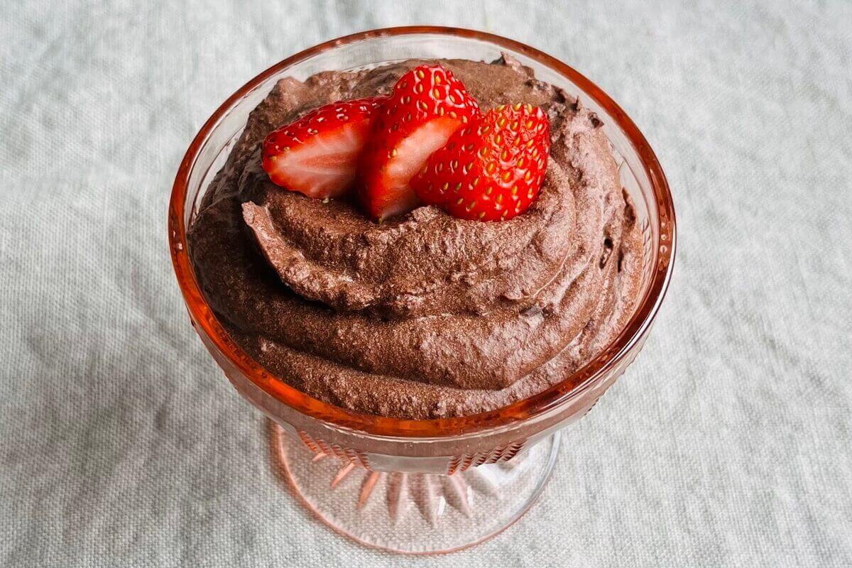 Chocolate mousse made with black beans in a glass dish.