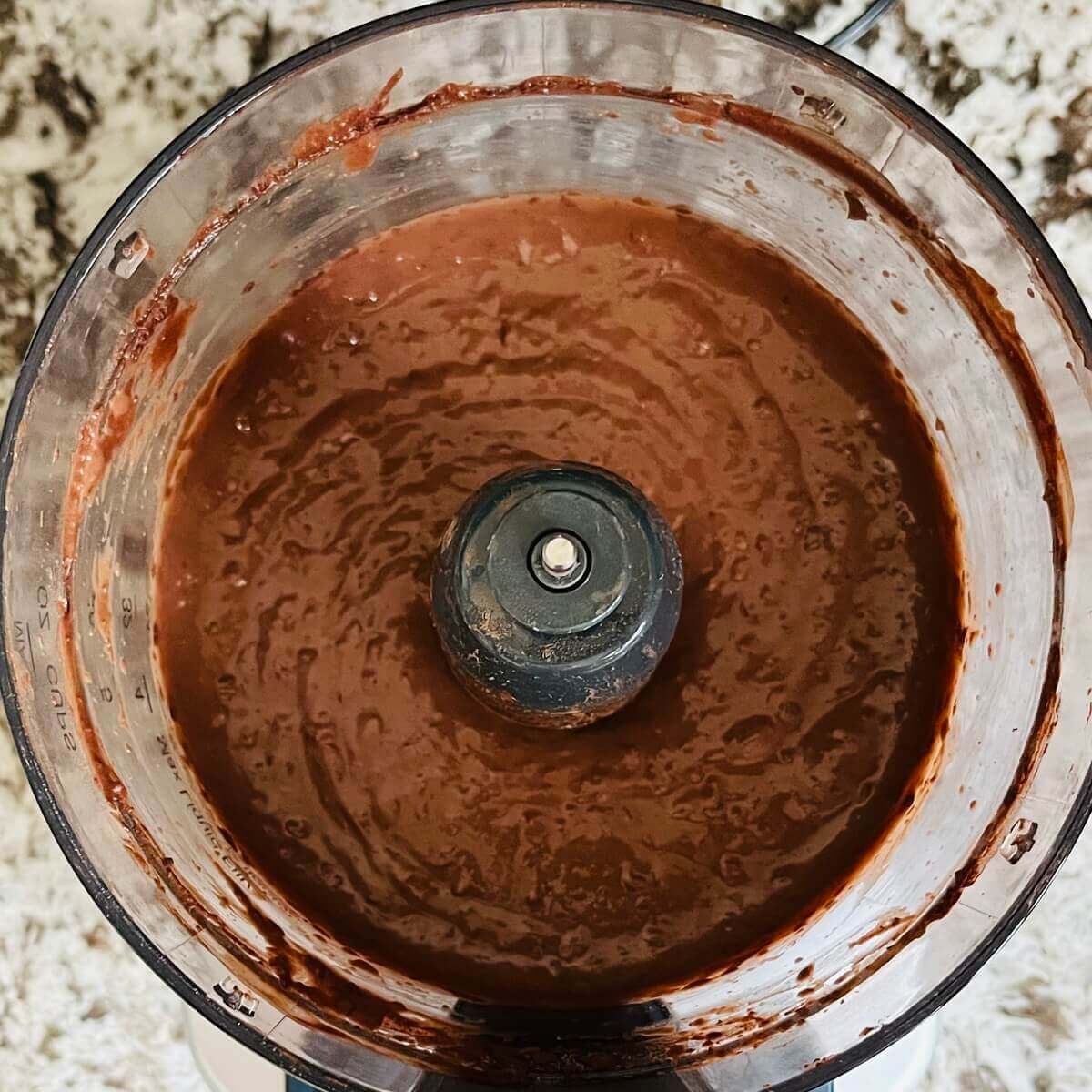 Black beans, cocoa powder, and other ingredients blended in a food processor.