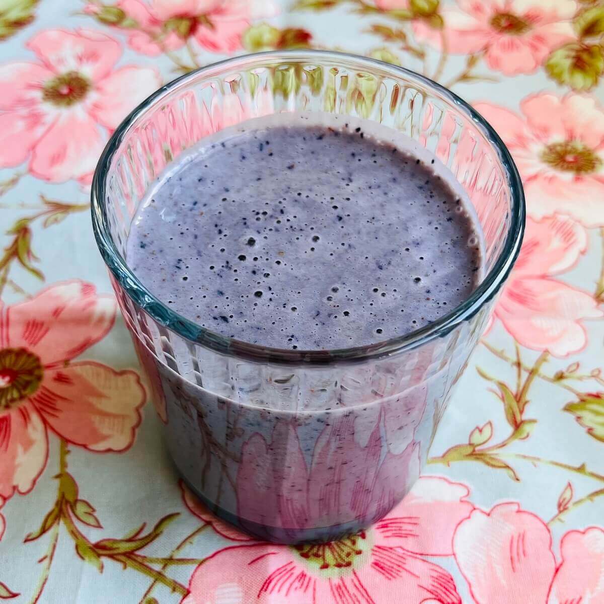 A blueberry almond butter smoothie in a glass.