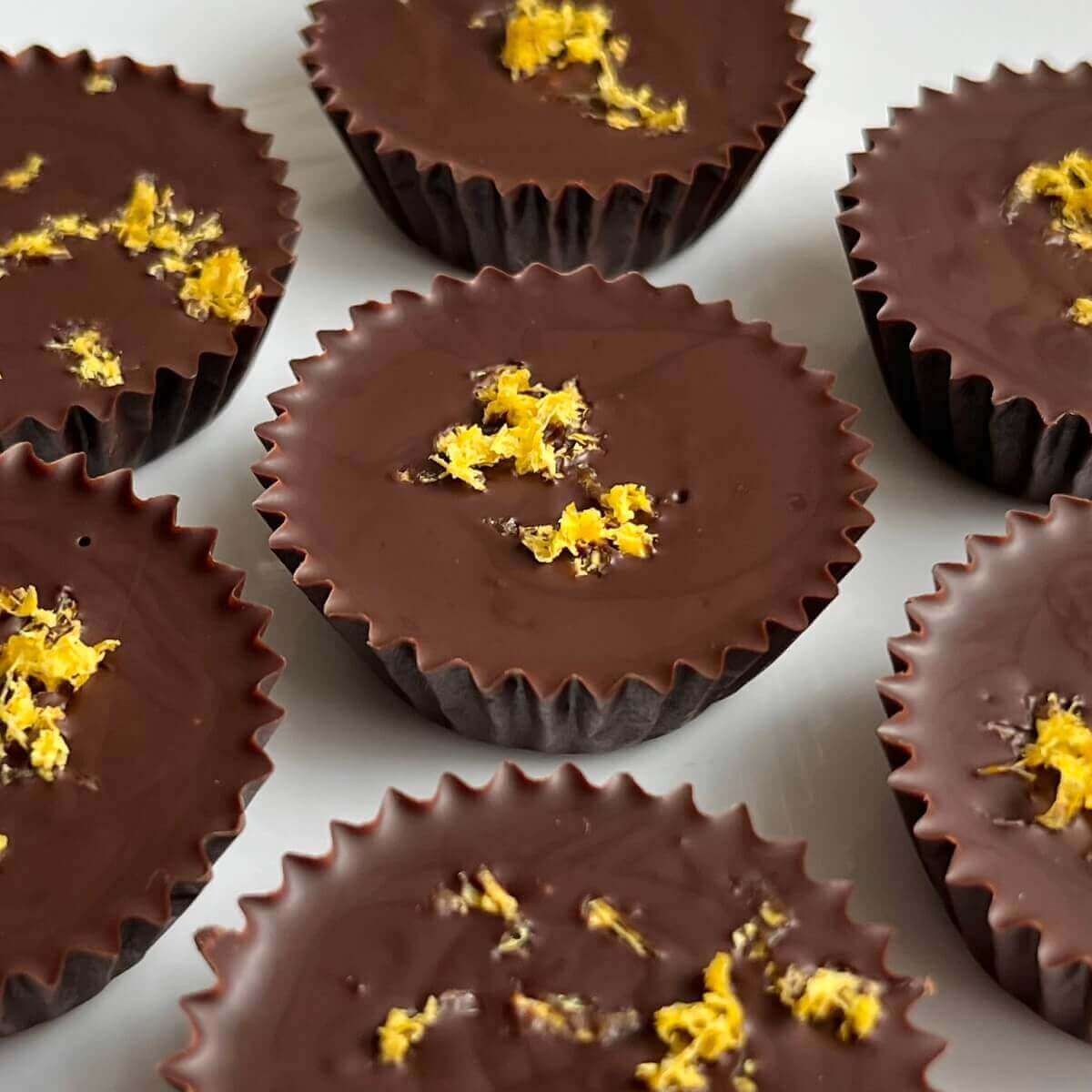 Lemon chocolates on a white plate.