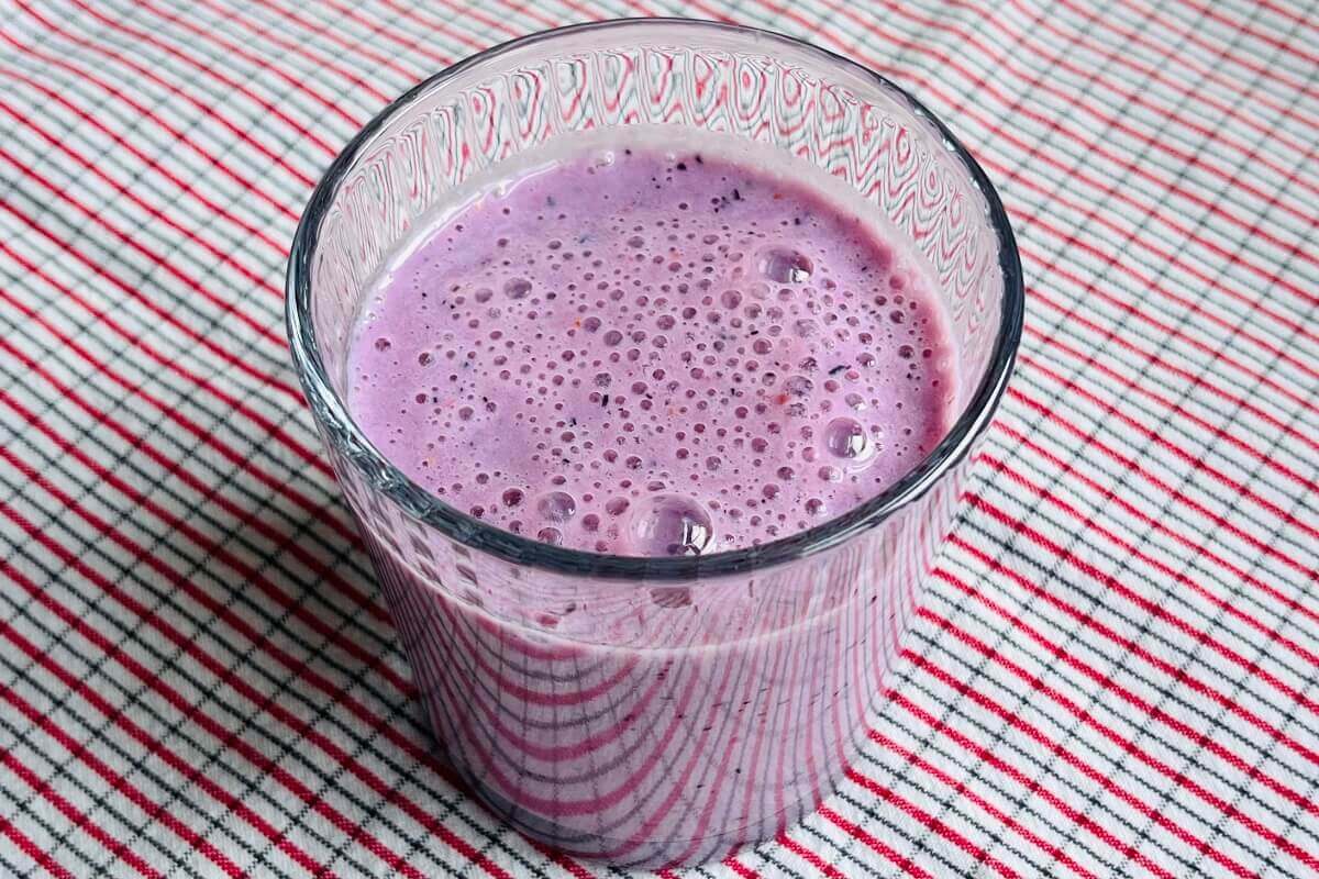 A purple smoothie in a glass.