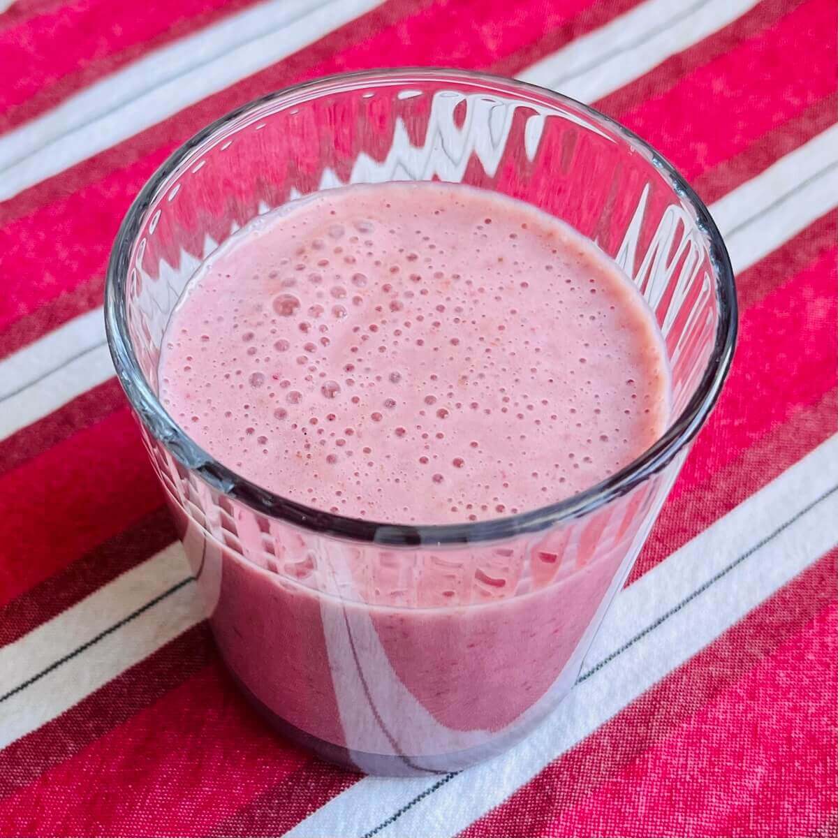 A strawberry date smoothie in a glass.