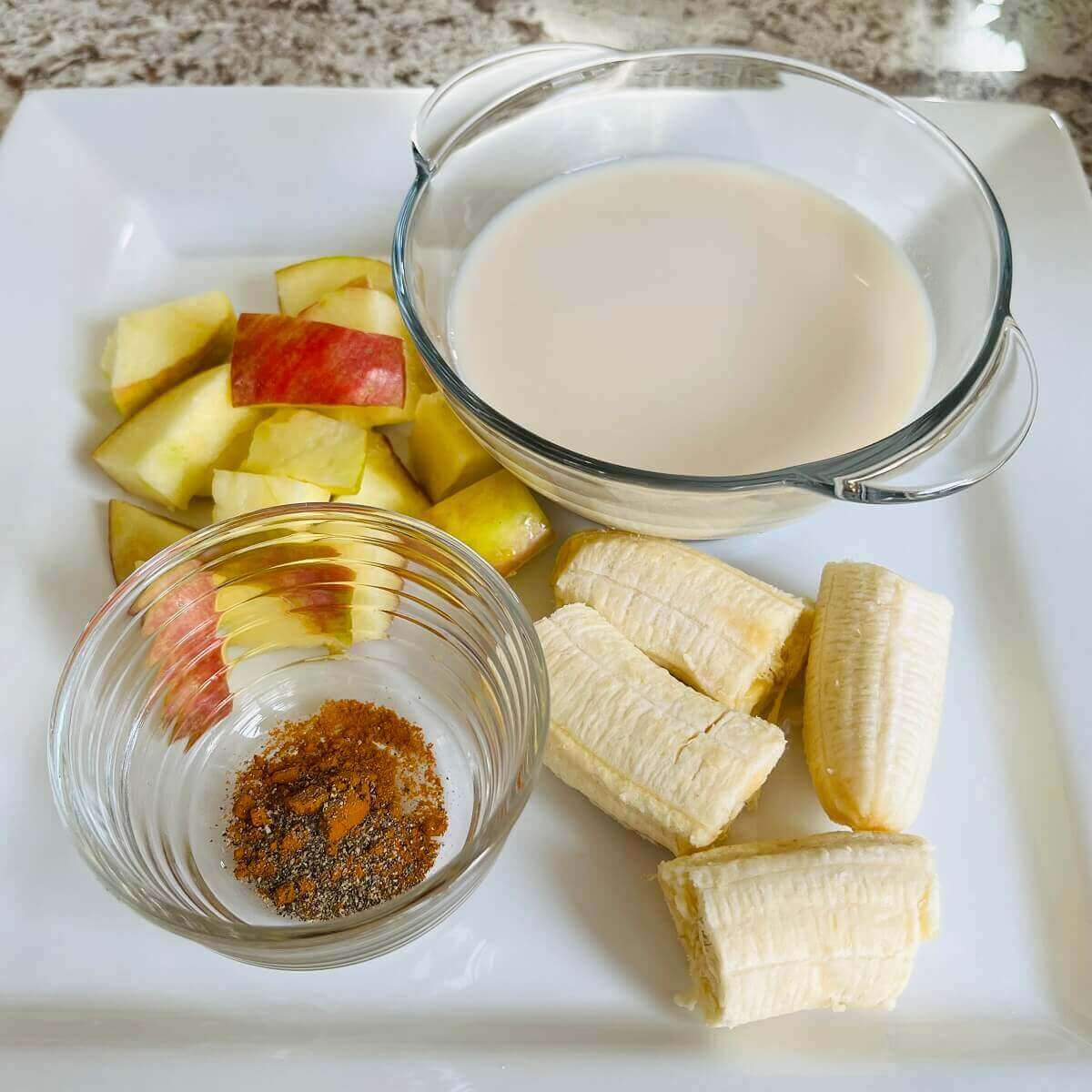Ingredients for a smoothie on a white plate.