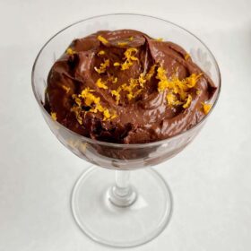 Chocolate orange pudding in a vintage glass dish.