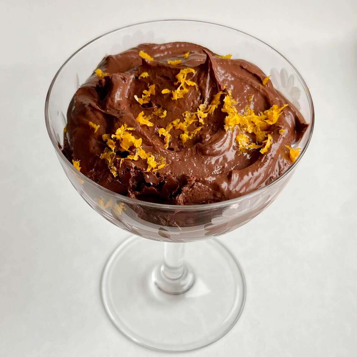 Chocolate orange pudding in a vintage glass dish.