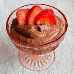 Chocolate strawberry pudding in a vintage glass dish.
