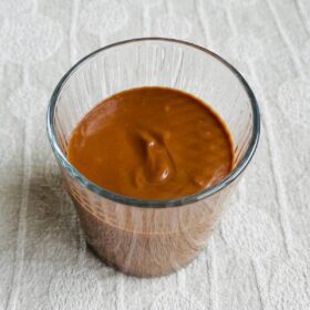 A chocolate sweet potato smoothie in a glass.