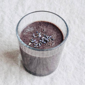 A lavender smoothie in a glass.