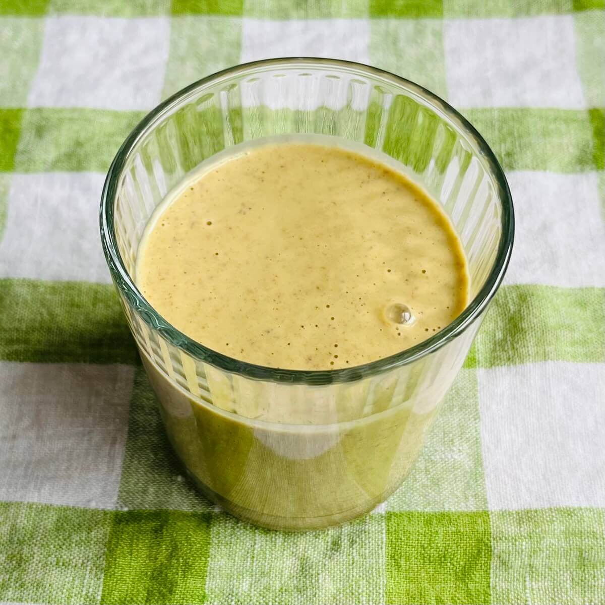 A pistachio smoothie in a glass.