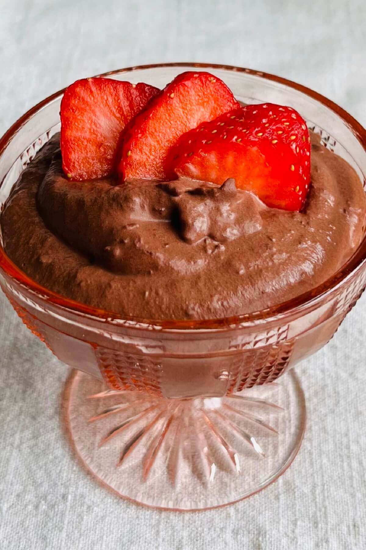 Pudding made with strawberries and chocolate in a glass dish.