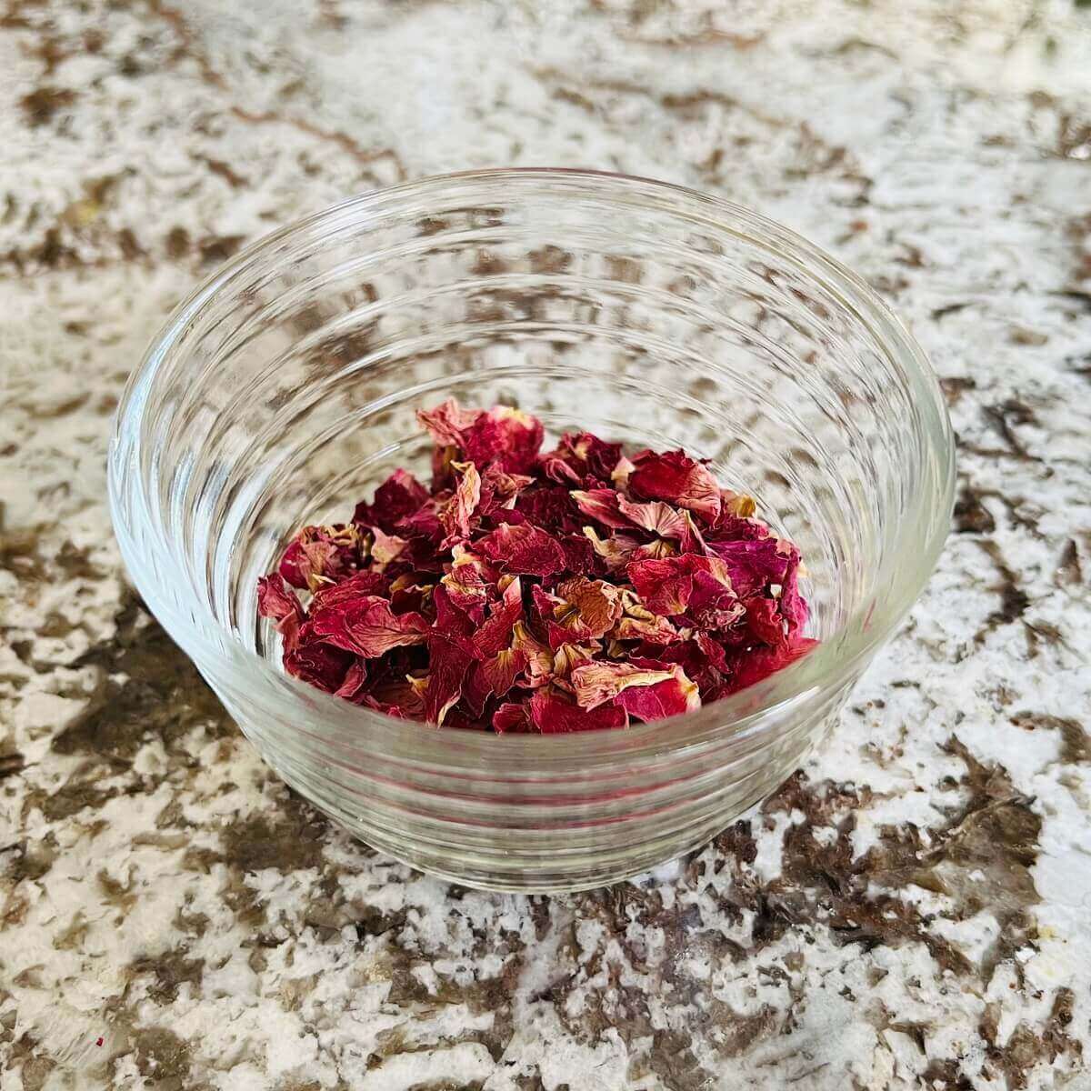 Dried rose petals in a glass bowl.