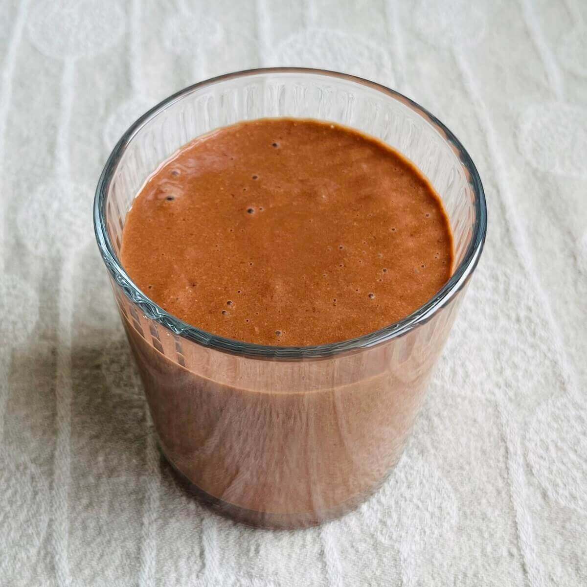 A creamy sunflower seed smoothie in a glass.