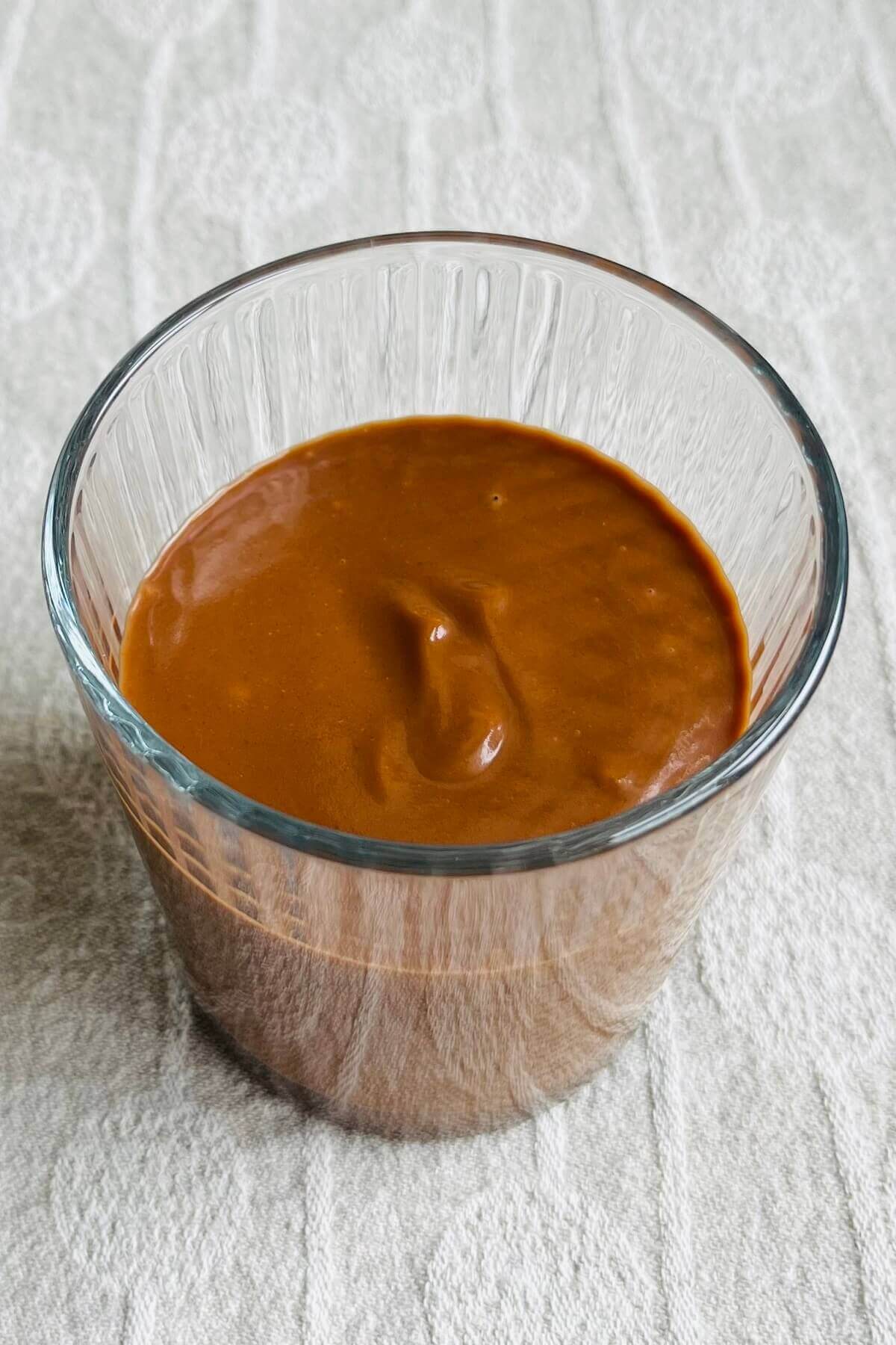 A sweet potato chocolate smoothie in a glass.