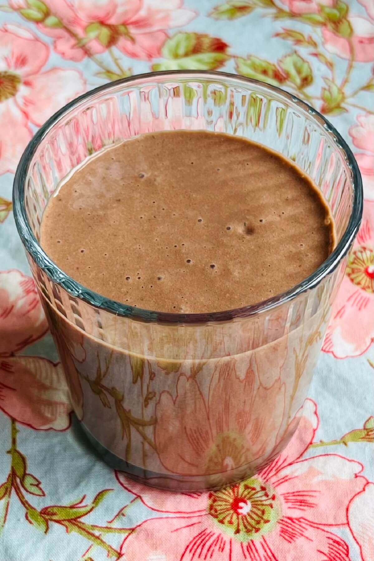 A smoothie made with walnuts in a glass.