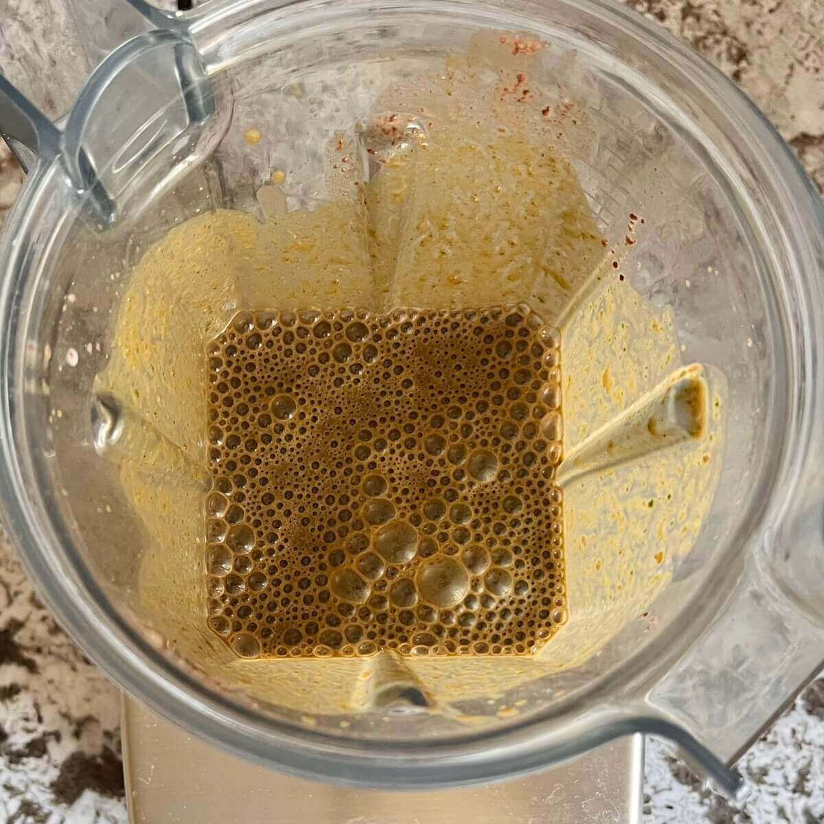 Spinach and other ingredients blended in a blender.