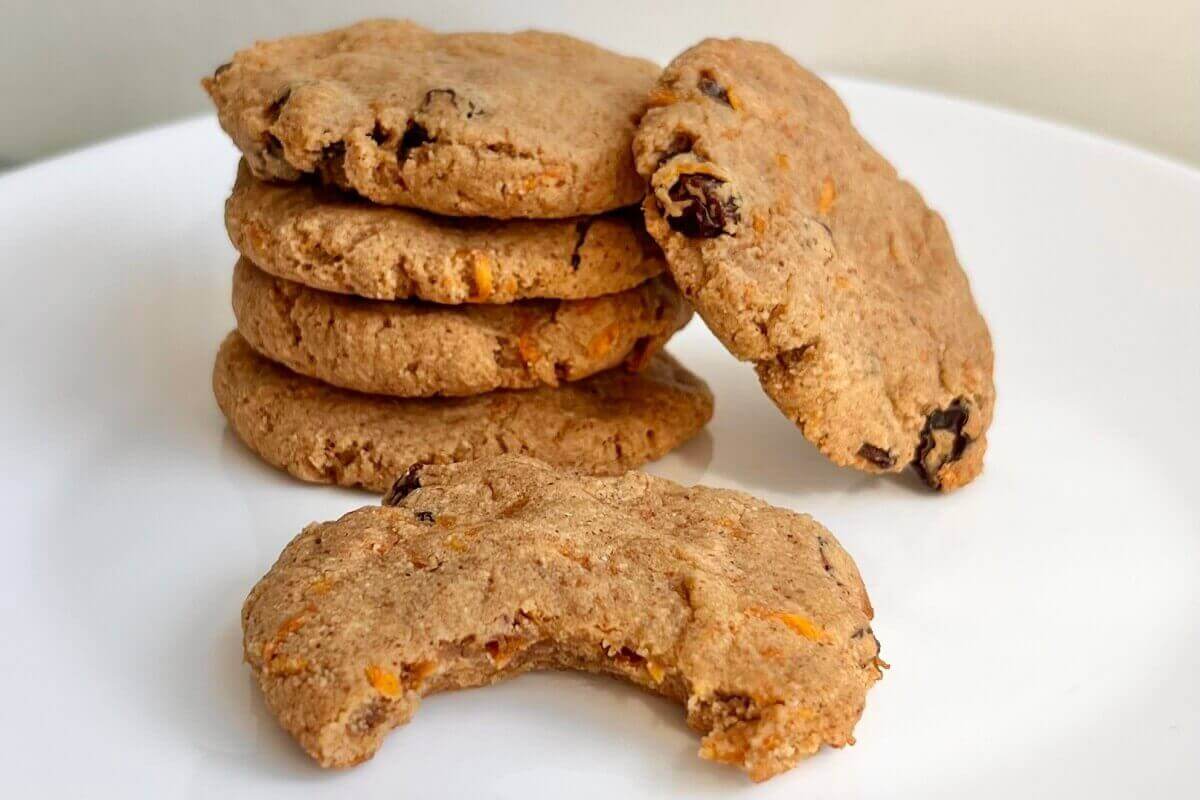 Gluten-free carrot cookies stacked on a white plate.