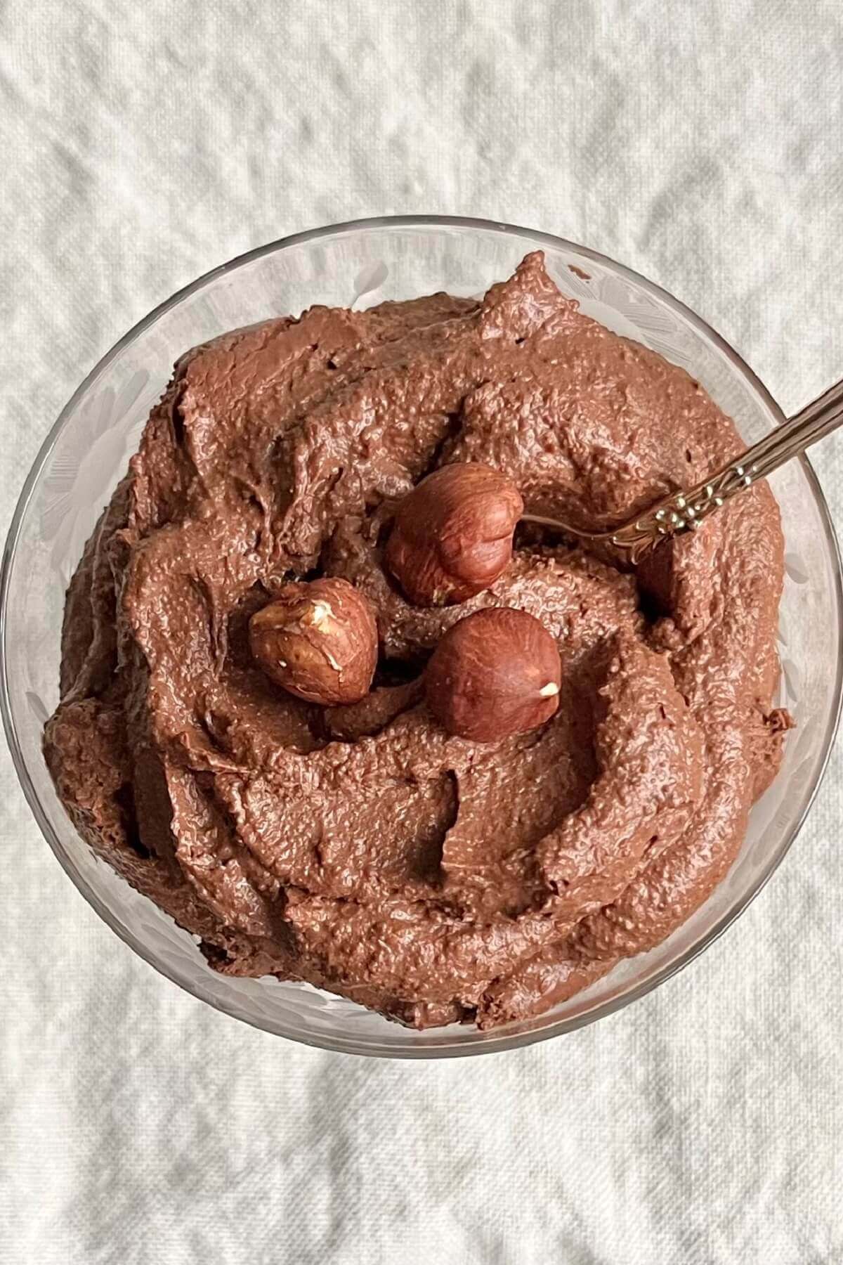 Mousse sprinkled with hazelnuts in a vintage dish.