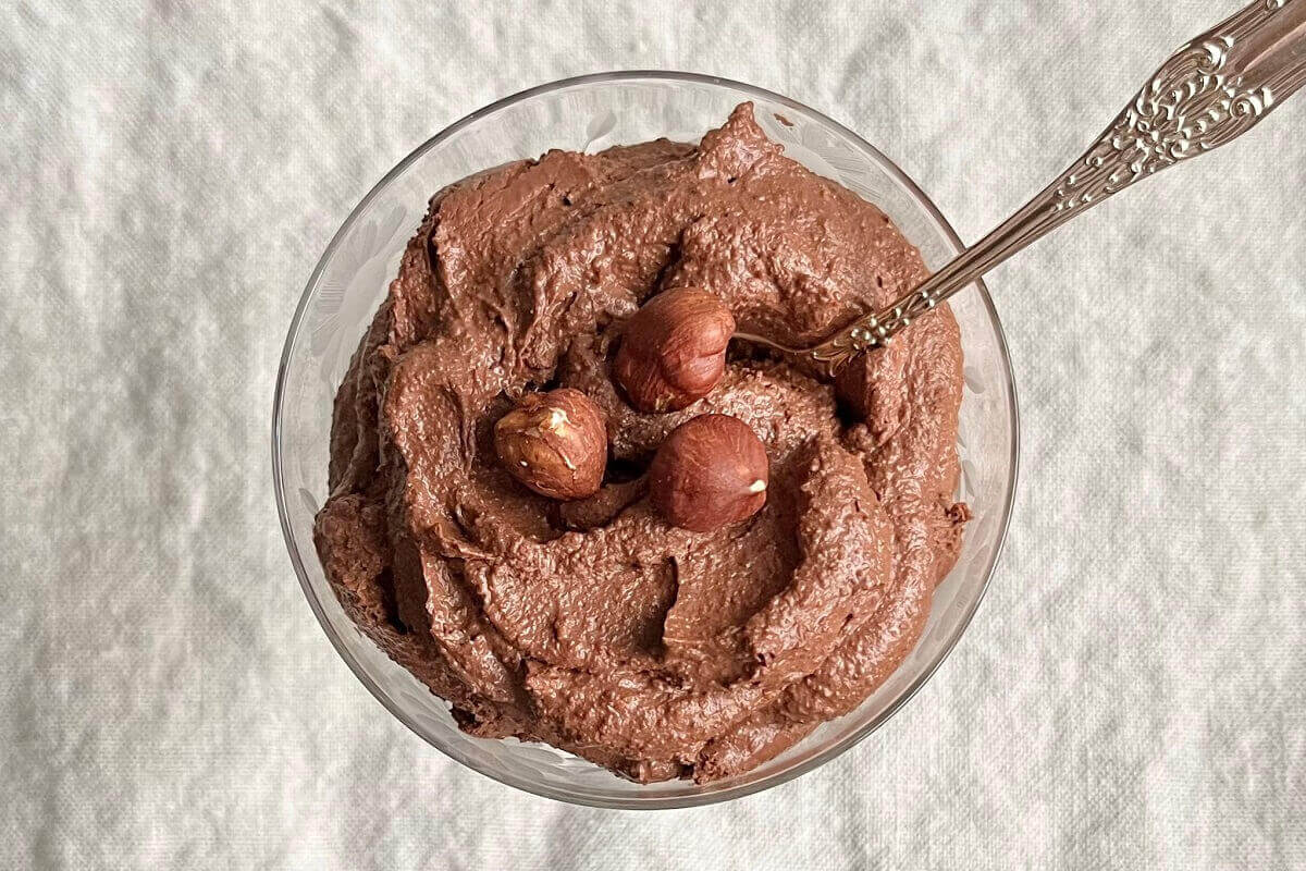 Mousse in a glass dish with an antique spoon.