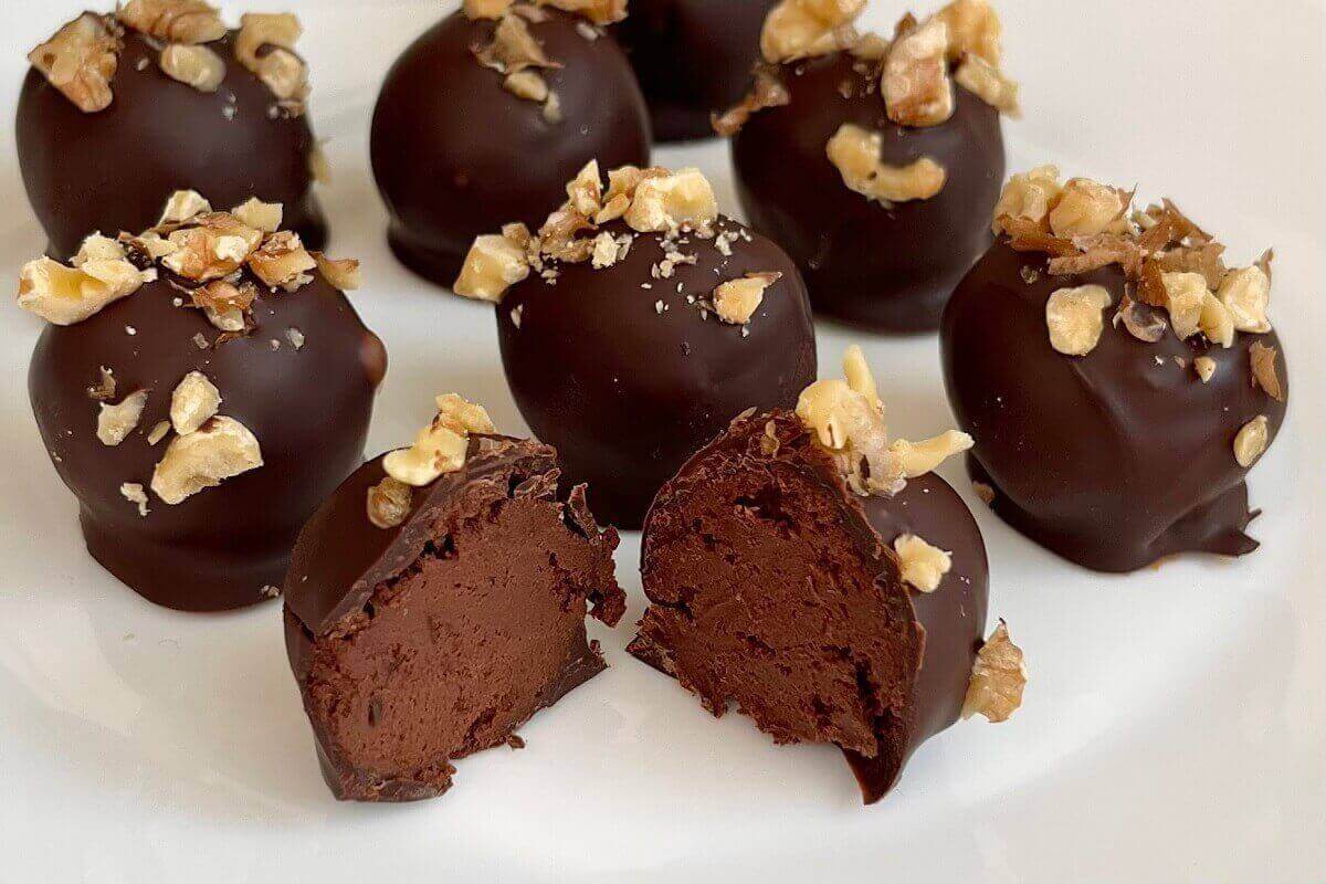 Chocolate truffles made with banana on a white plate.