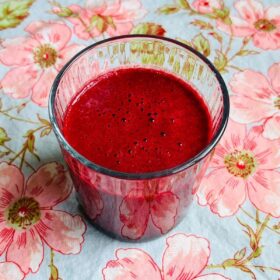 A red velvet smoothie in a glass.