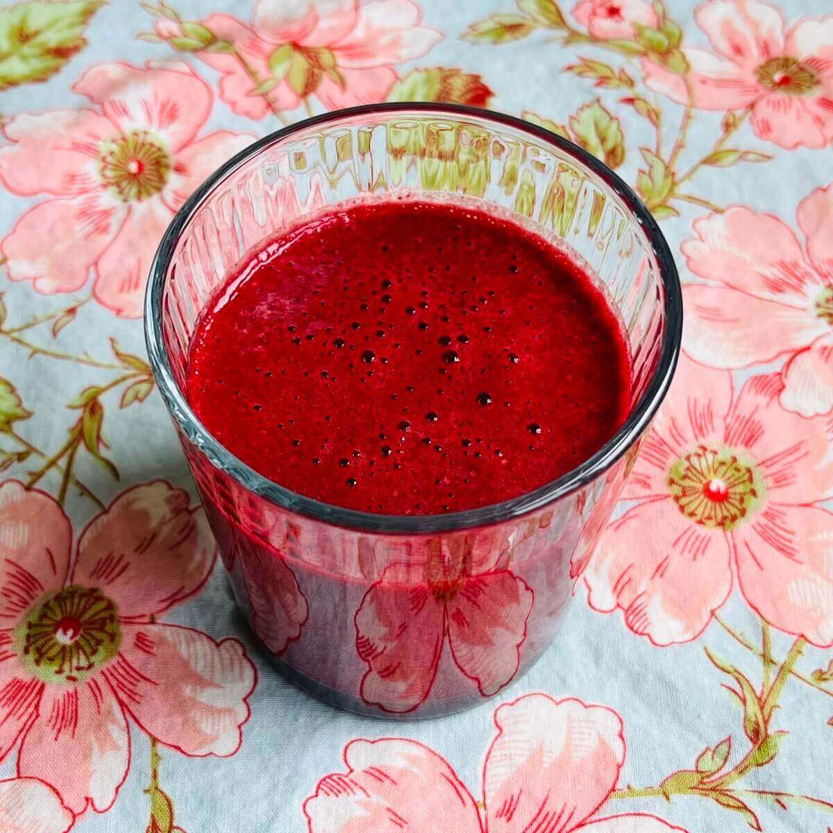 A red velvet smoothie in a glass.