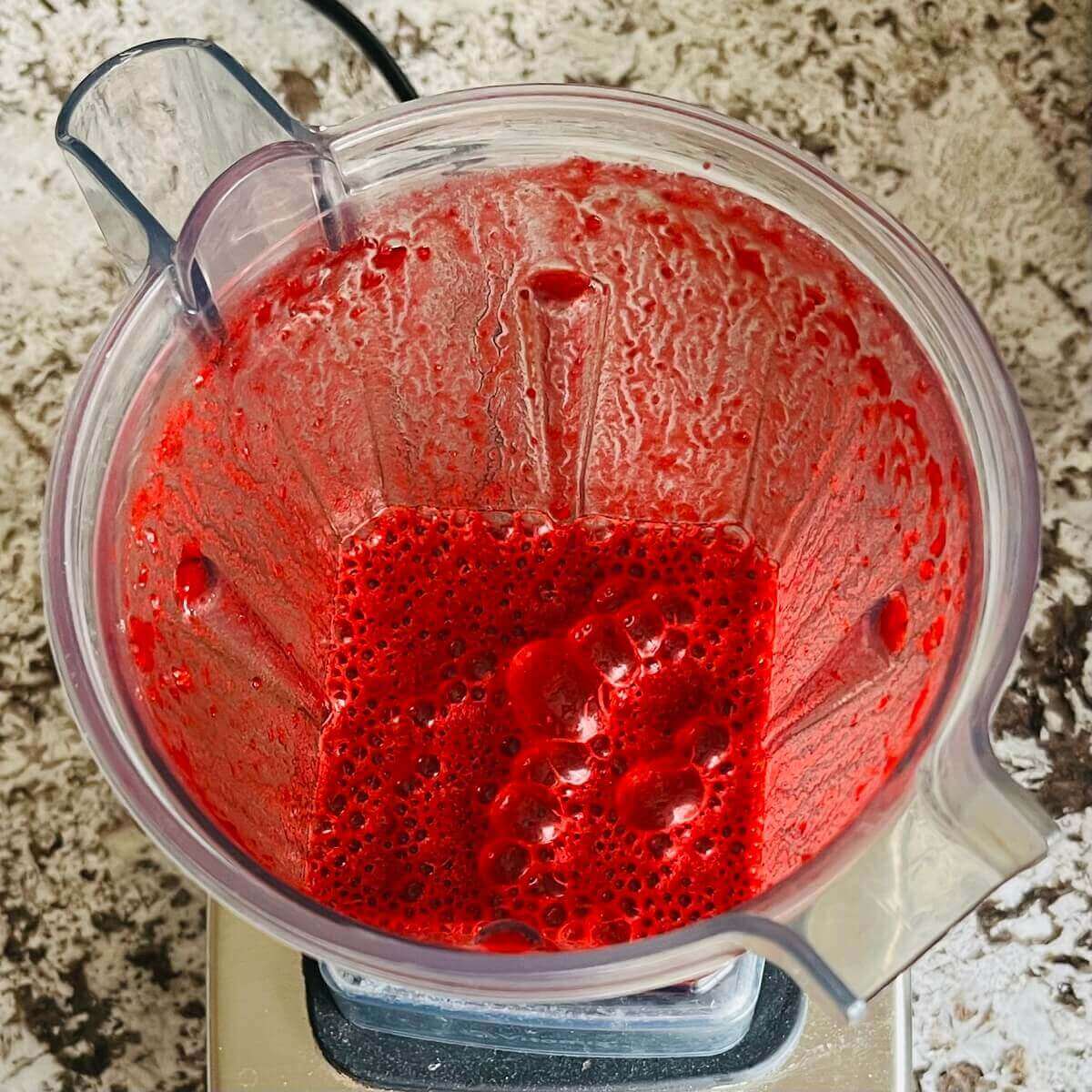 A smoothie made with beet juice blended in a blender.