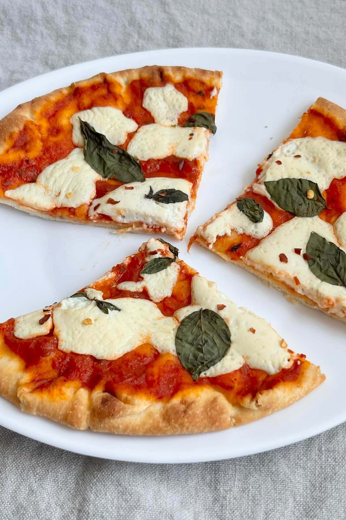 Vegan pizza on a white plate.