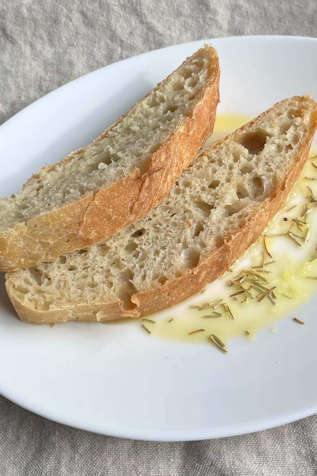 Two slices of artisan bread on a plate.