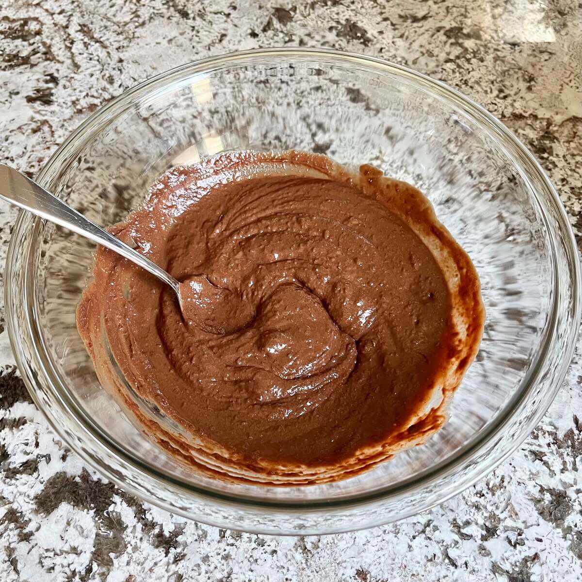Blended lentils and other ingredients for brownie batter in a glass bowl.