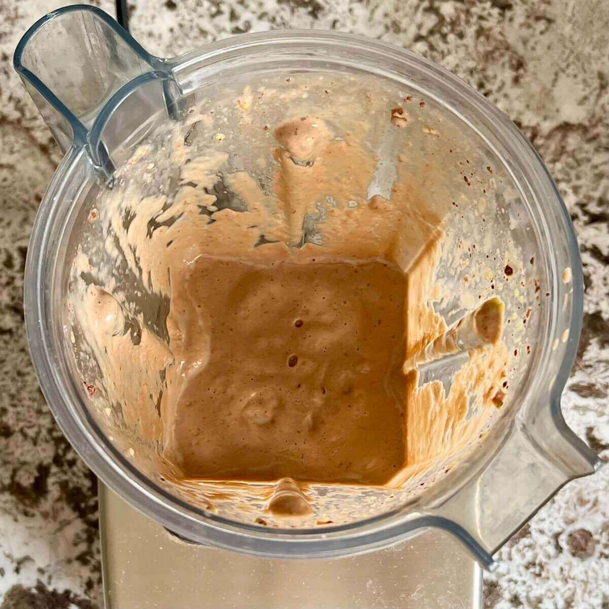 A smoothie made with avocado and dates in a blender.