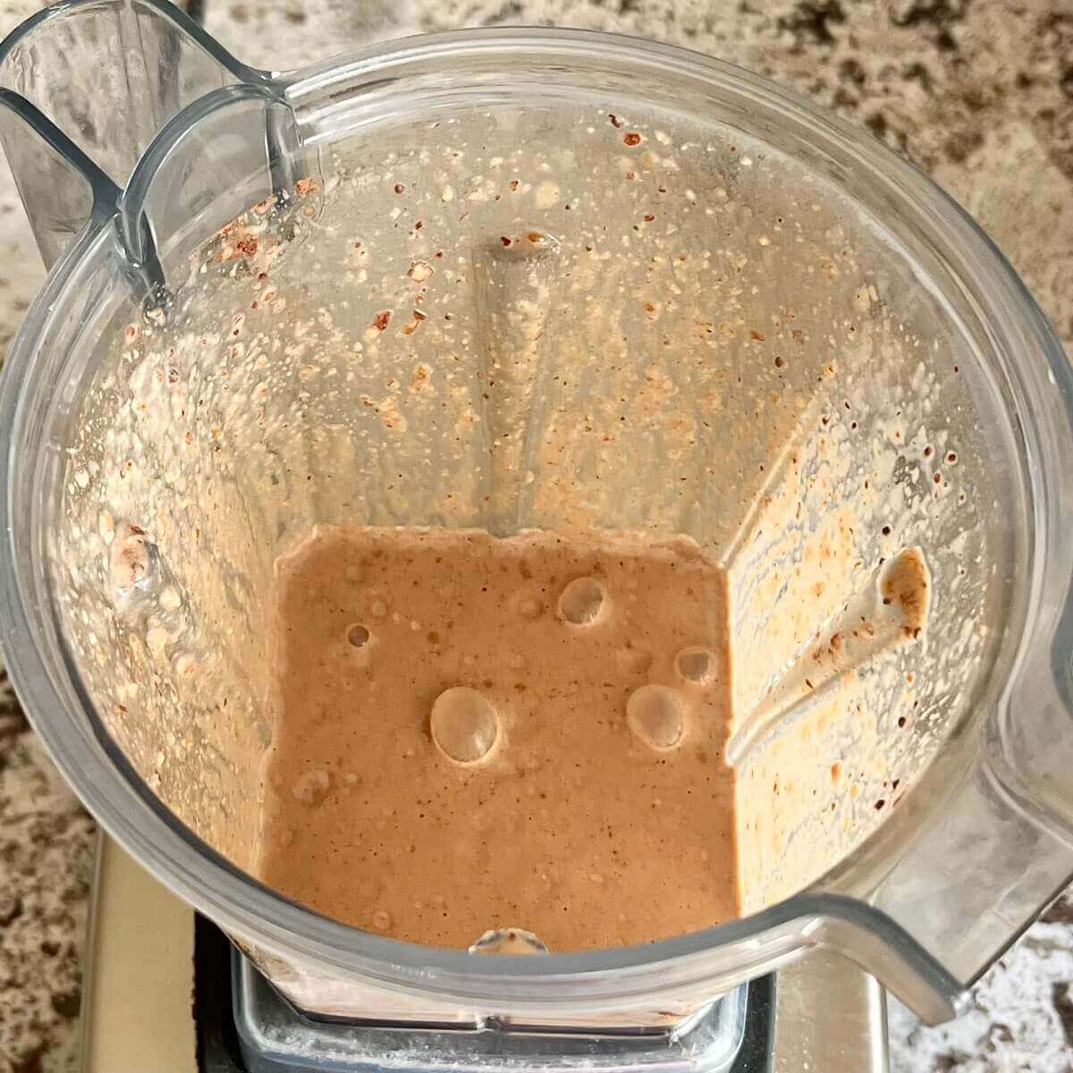 Hazelnuts and other smoothie ingredients blended in a blender.