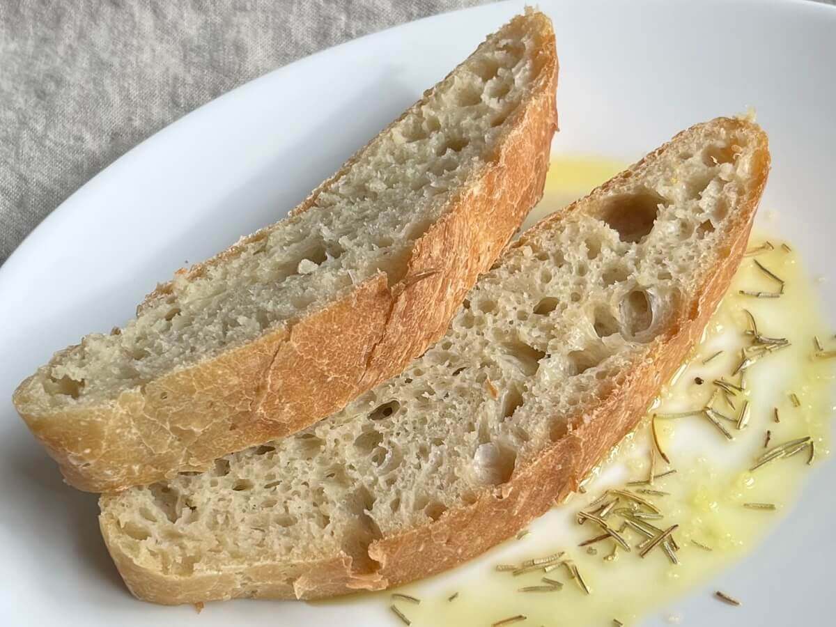 Two slices of bread on a white plate.