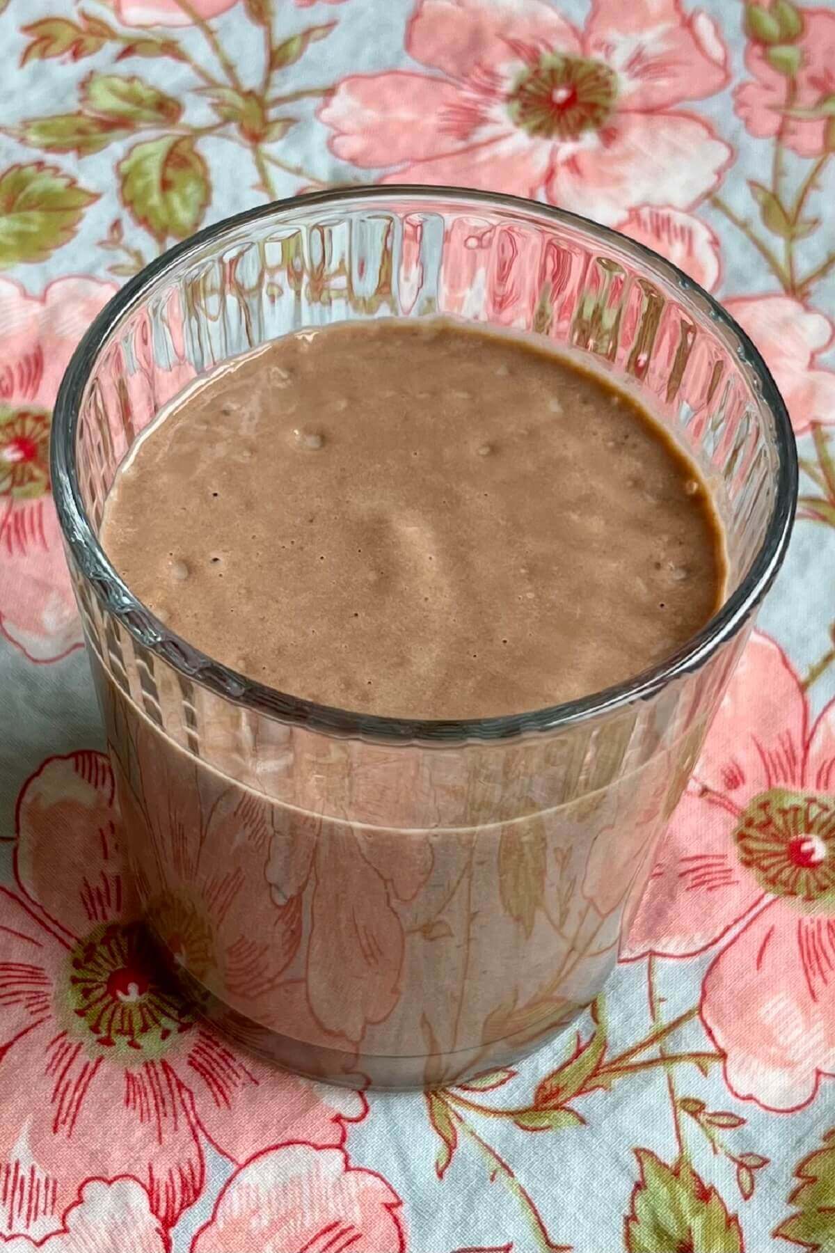 A date avocado shake in a glass.