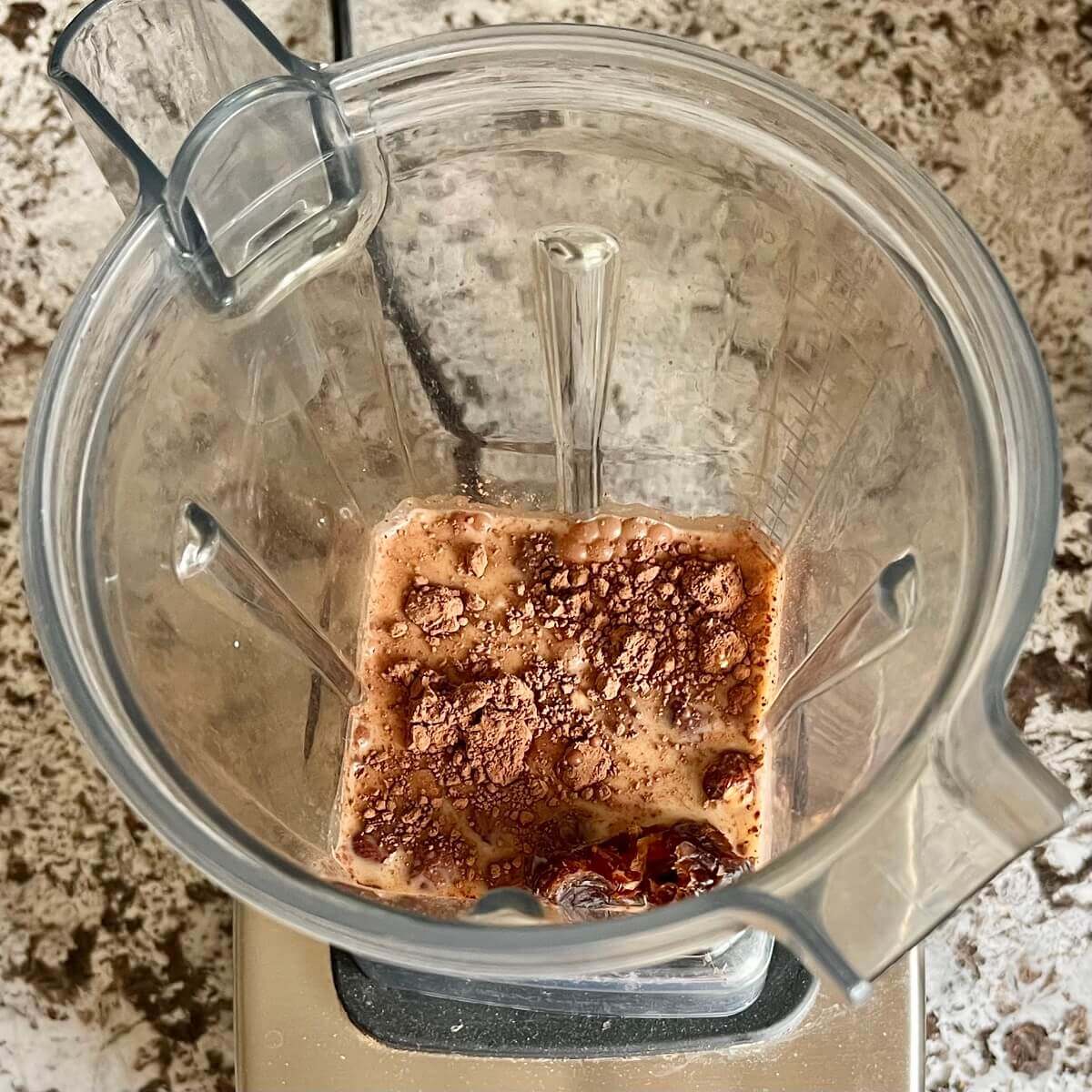 Hazelnuts, dates, cocoa powder, soy milk, and sea salt in a blender.