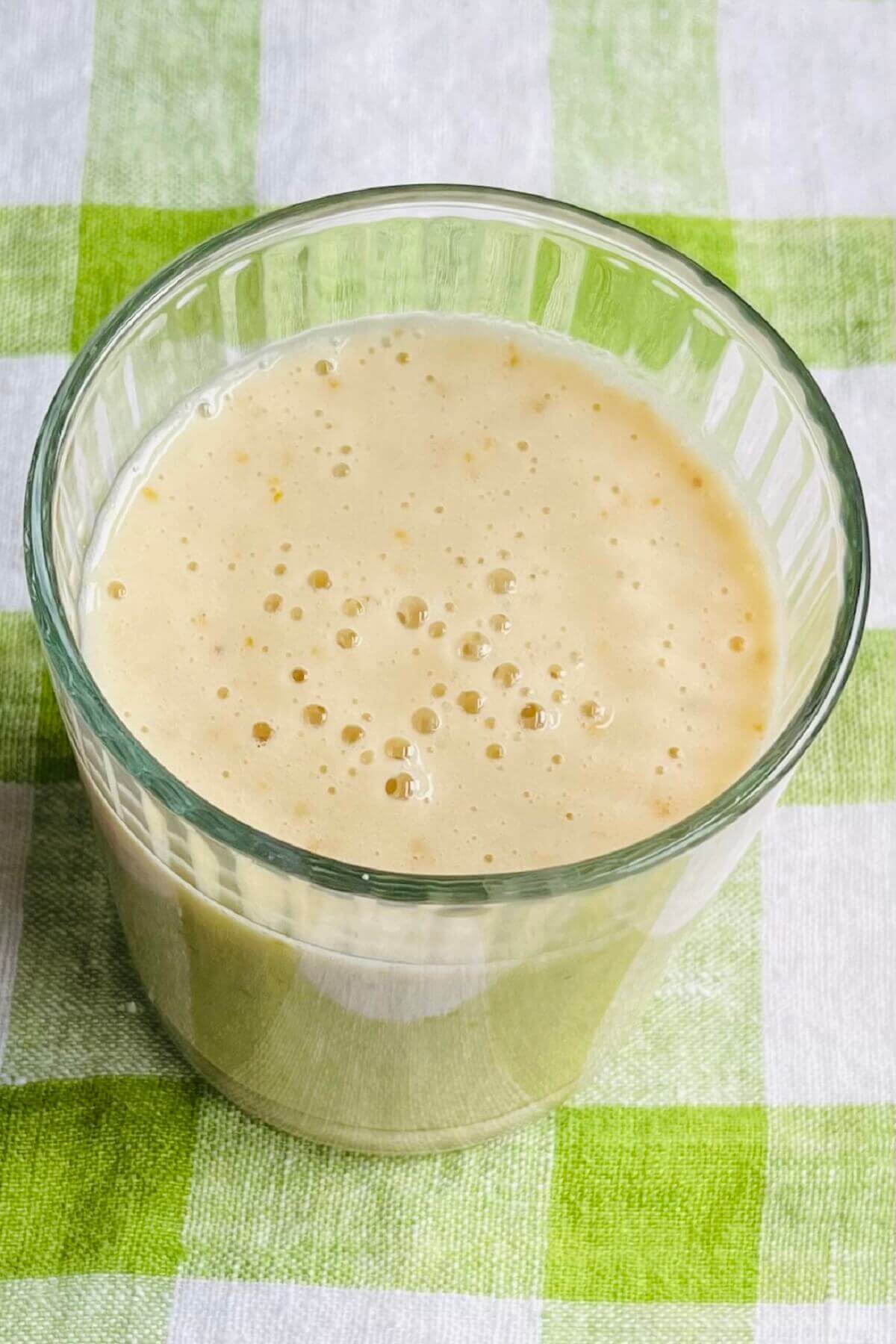 A pear banana shake in a glass.