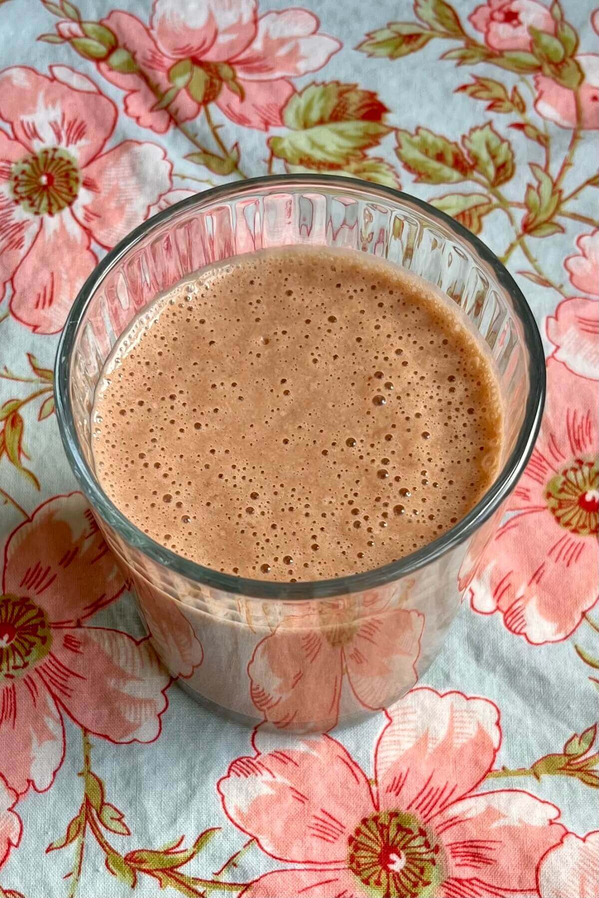 A creamy pineapple shake in a glass.