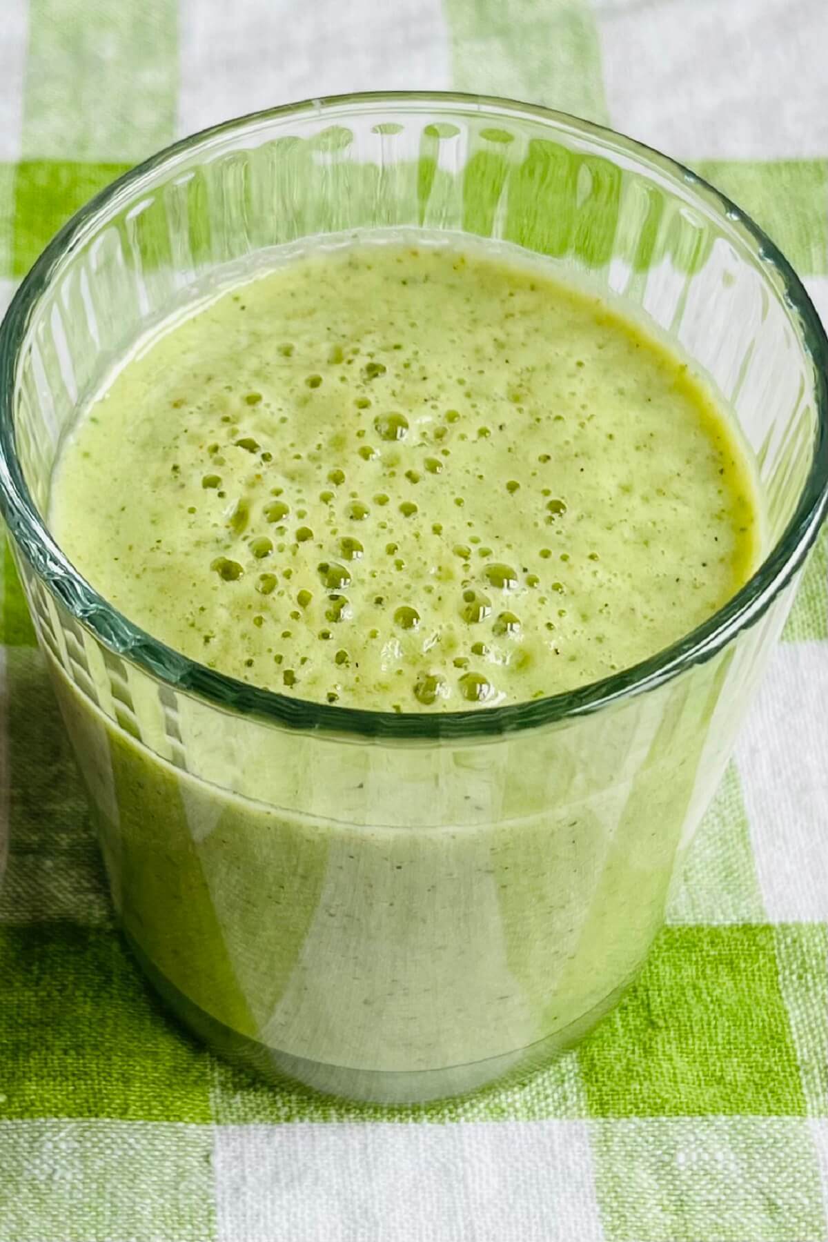 A creamy green smoothie in a glass.